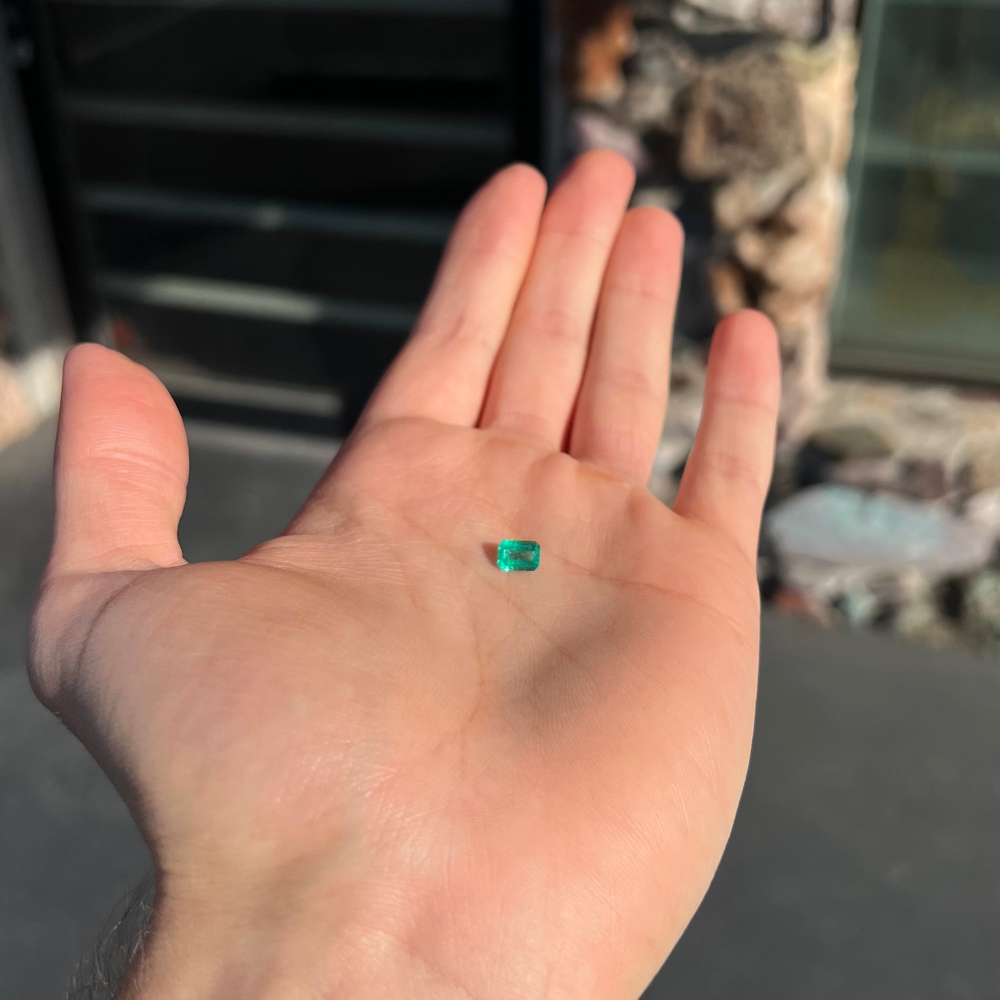 A loose, natural emerald gemstone.  The stone is emerald cut.