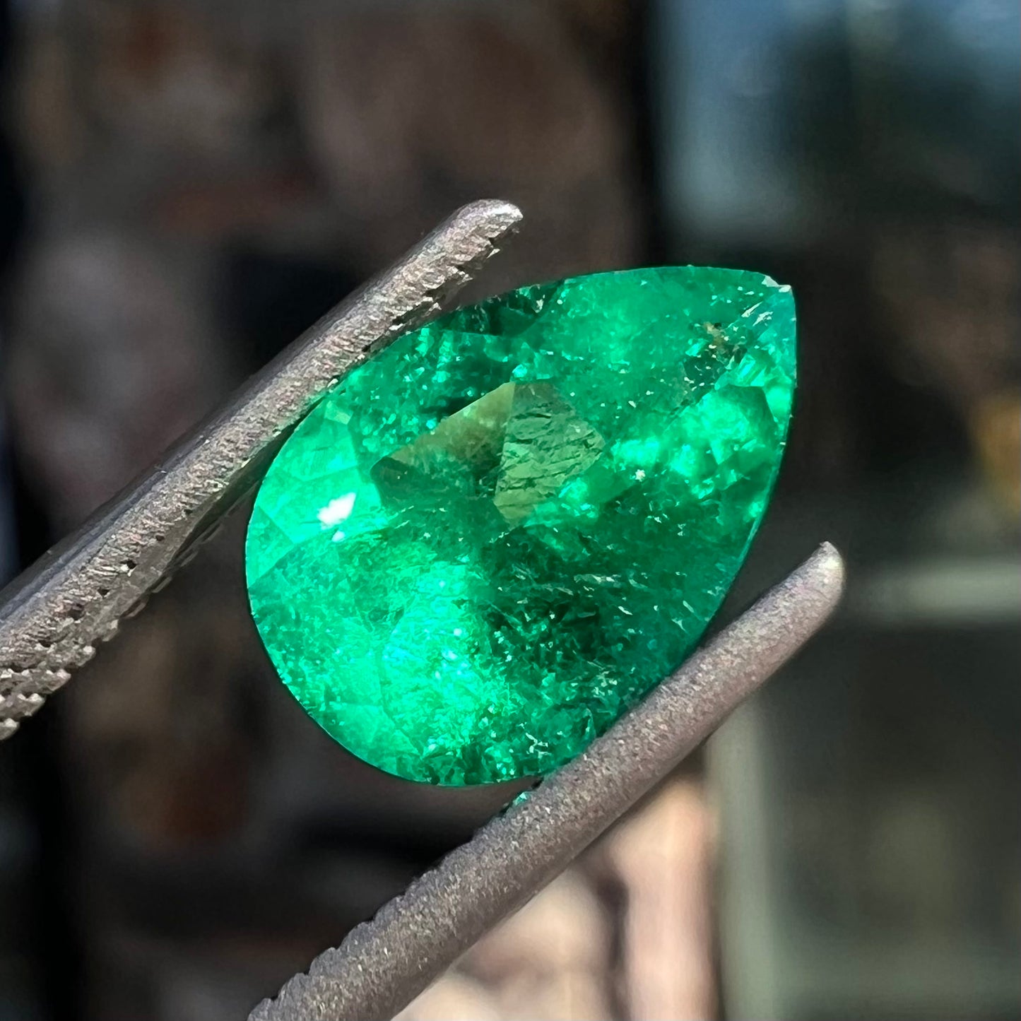 A loose, pear shaped natural emerald gemstone.