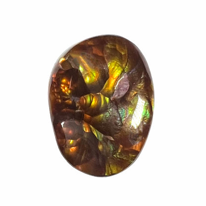 A loose, oval cabochon cut fire agate gemstone.  The stone is bubbly green with blue overtones.