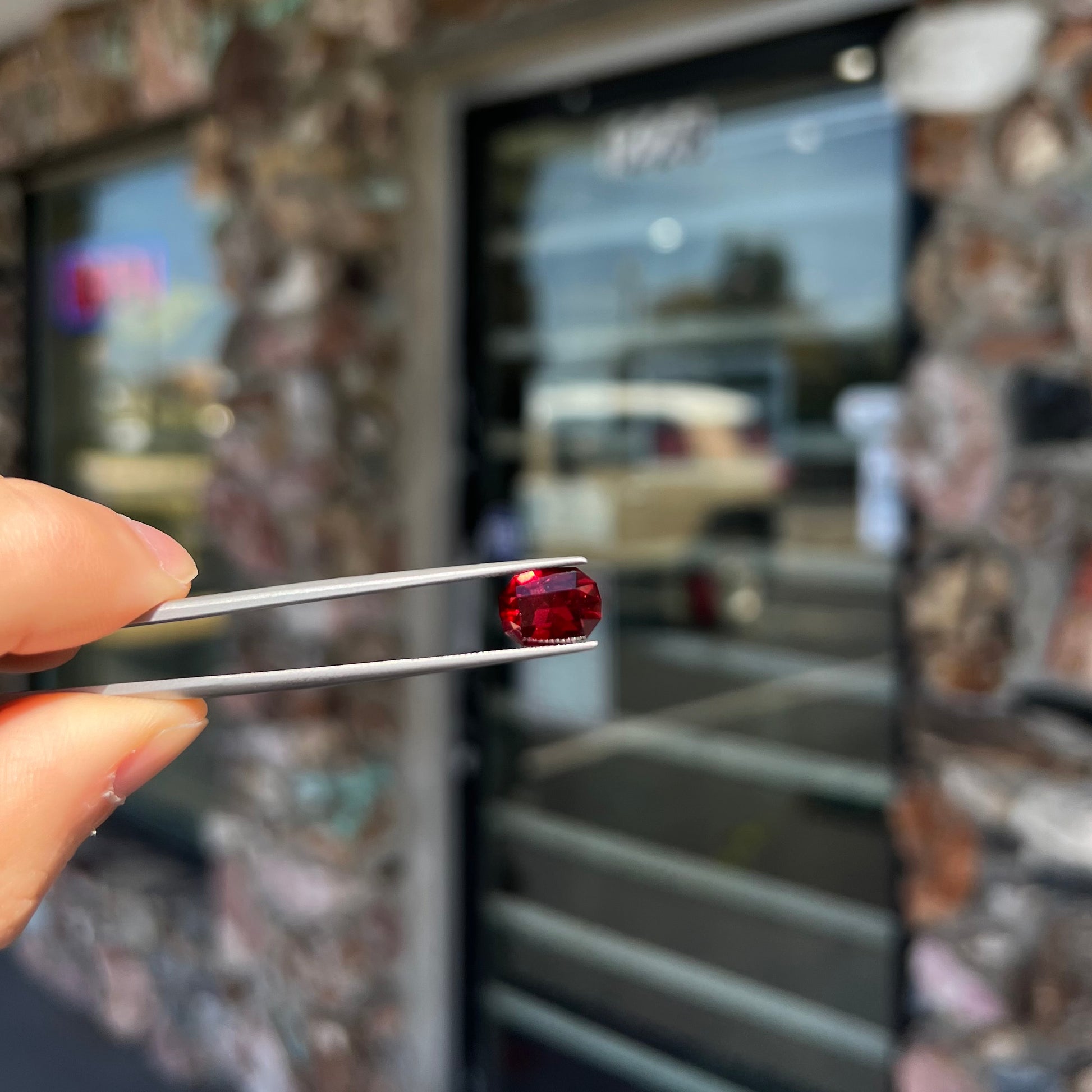 A loose, octagon cut rhodolite garnet gemstone.  The stone is a deep, purplish crimson red color.
