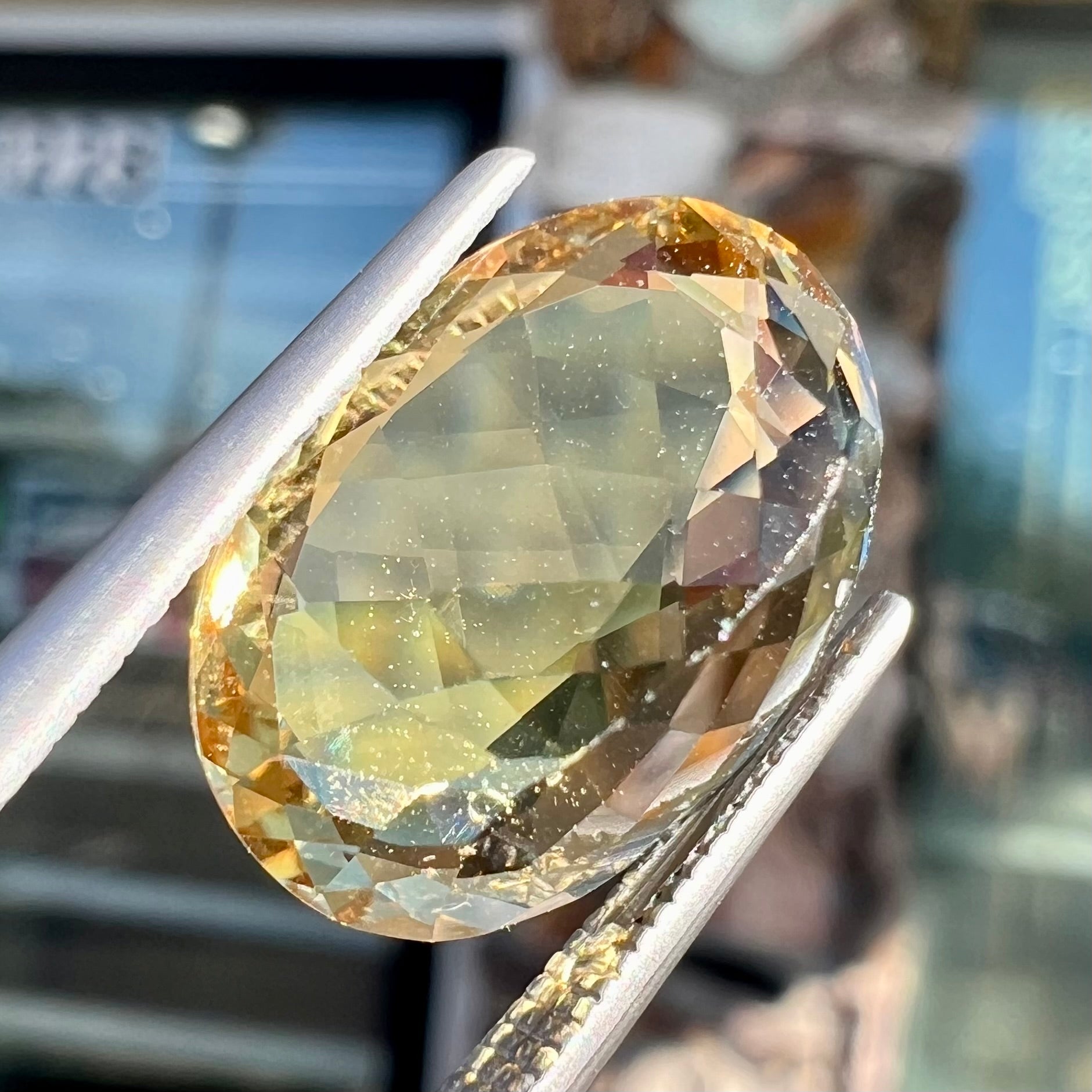 A faceted, oval cut golden beryl gemstone.