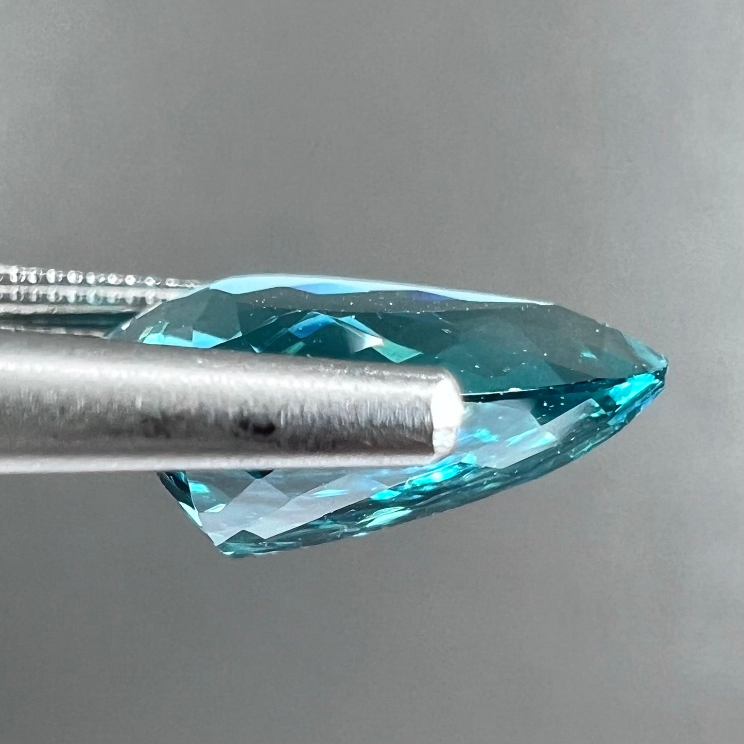 A loose, pear shaped green-blue indicolite tourmaline stone.