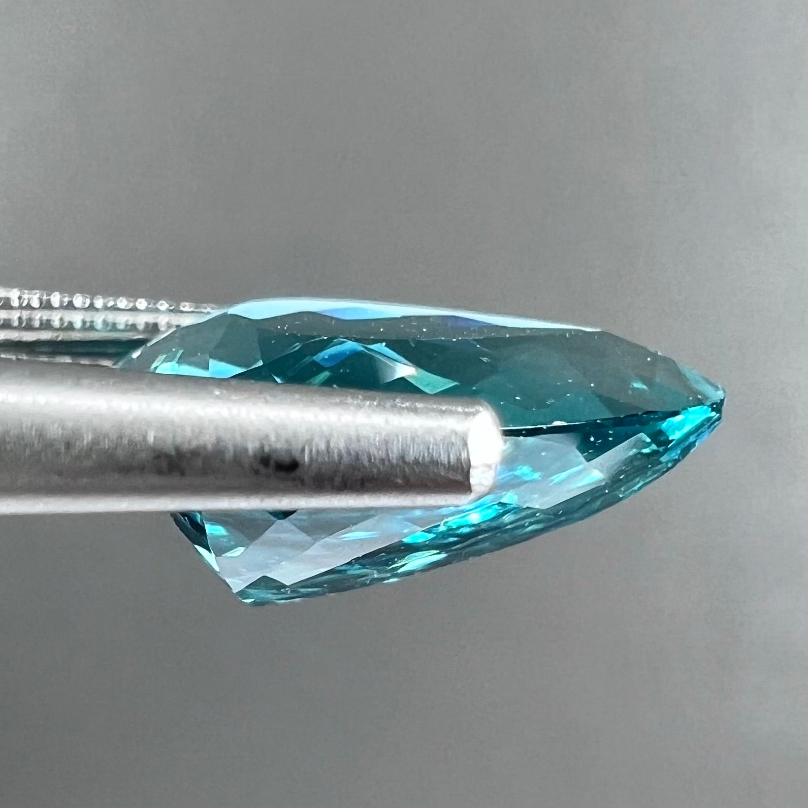 A loose, pear shaped green-blue indicolite tourmaline stone.