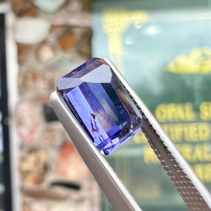 A loose, emerald cut blue iolite gemstone.