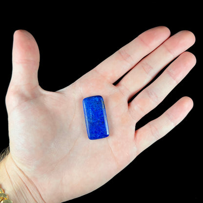 A loose, rectangle cabochon cut AA grade blue lapis lazuli stone.