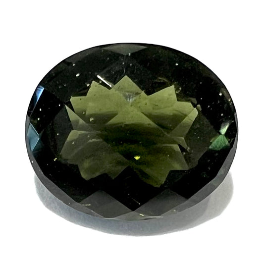 A loose, oval checkerboard cut natural moldavite gemstone.  The stone is dark green color and weighs 4.18 carats.