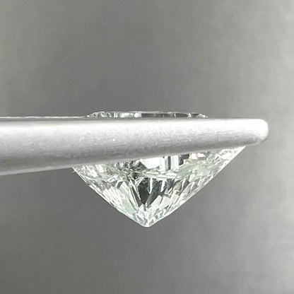 A loose, triangular fantasy cut prasiolite gemstone.  Prasiolite is a light green variety of quartz.