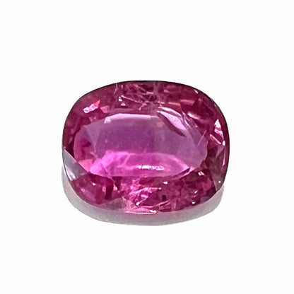 A loose, faceted oval cut natural purple sapphire gemstone that weighs 1.26 carats.