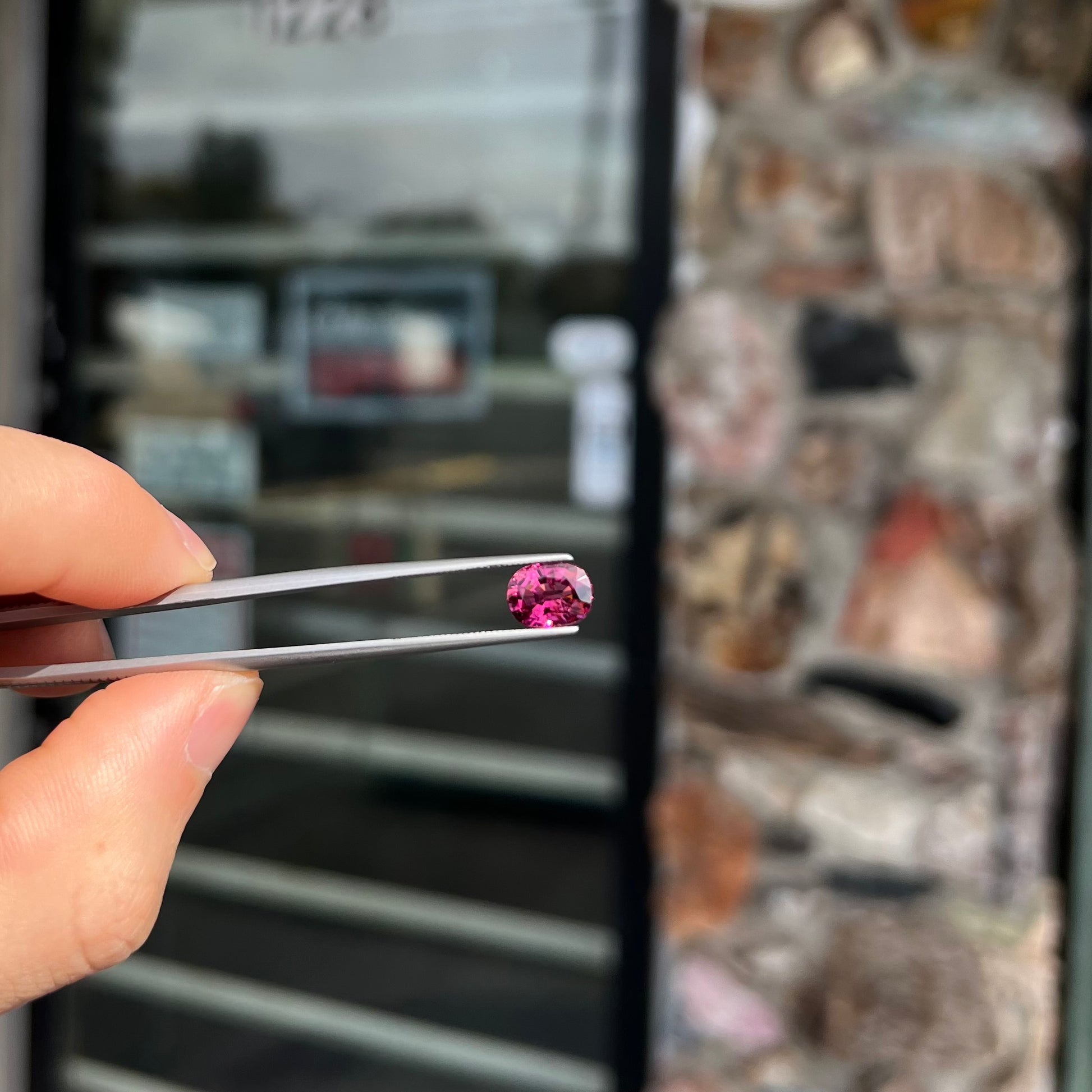 A loose, faceted oval cut purple tourmaline gemstone.  The stone weighs 2.08 carats.