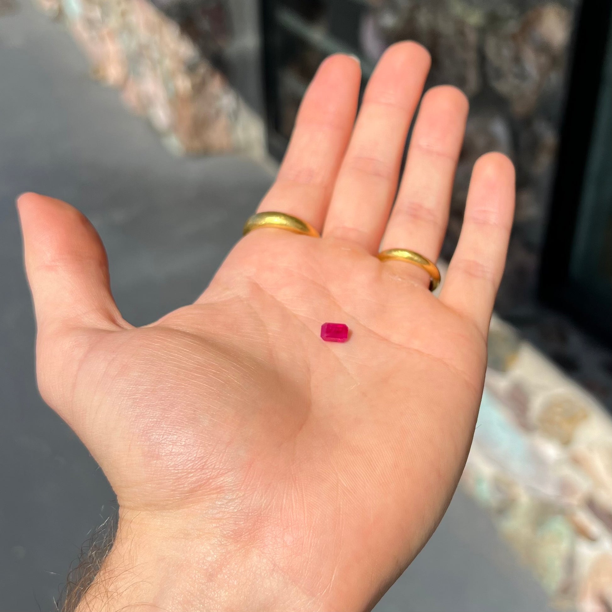 A natural, emerald cut Burma ruby gemstone.  The stone is pinkish red color.