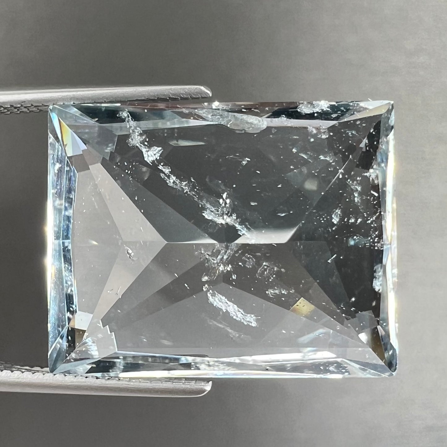 A loose, faceted French cut Russian topaz gemstone.  The stone is a light blue color.