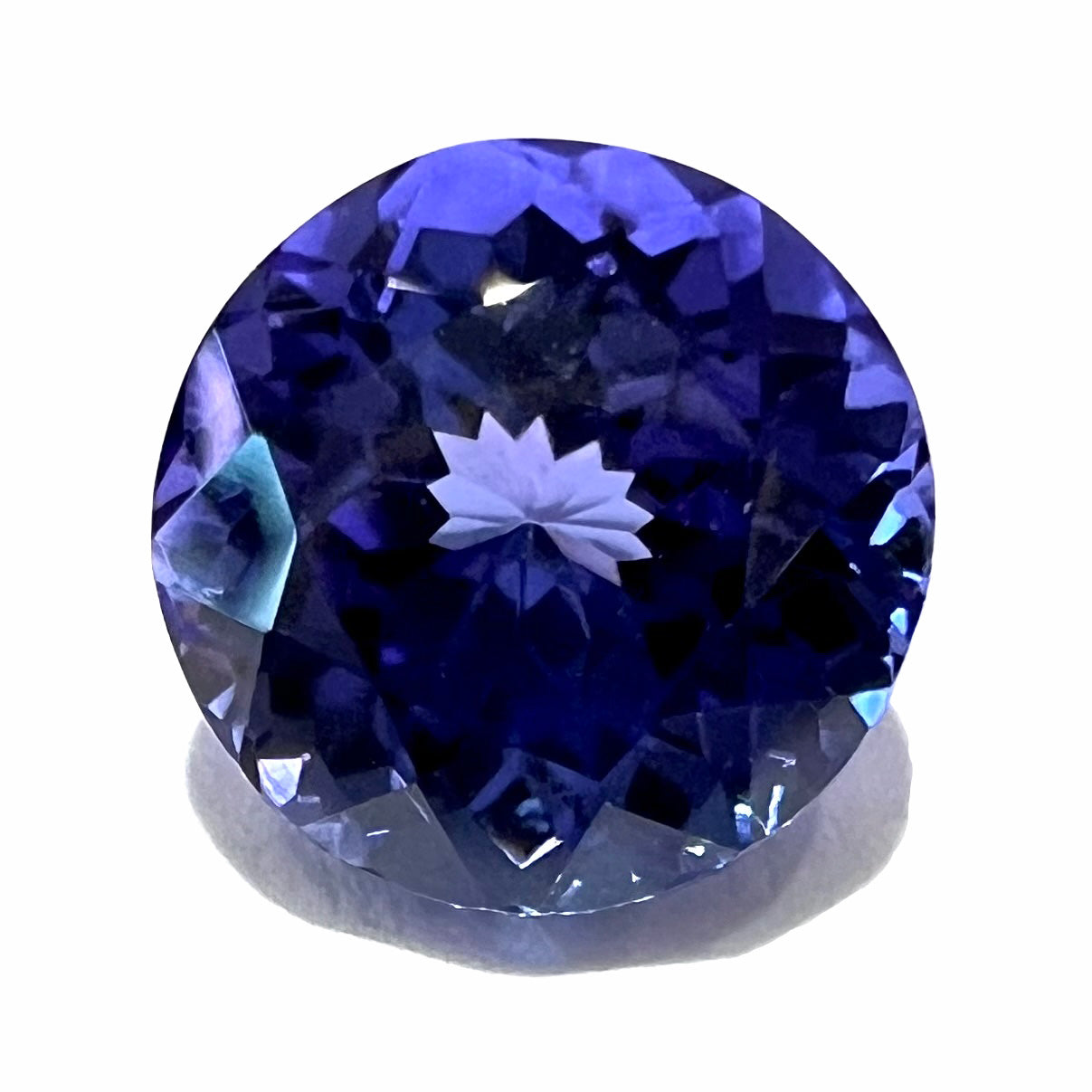 A loose, natural tanzanite gemstone.  The stone is round brilliant cut and weighs 2.42 carats.