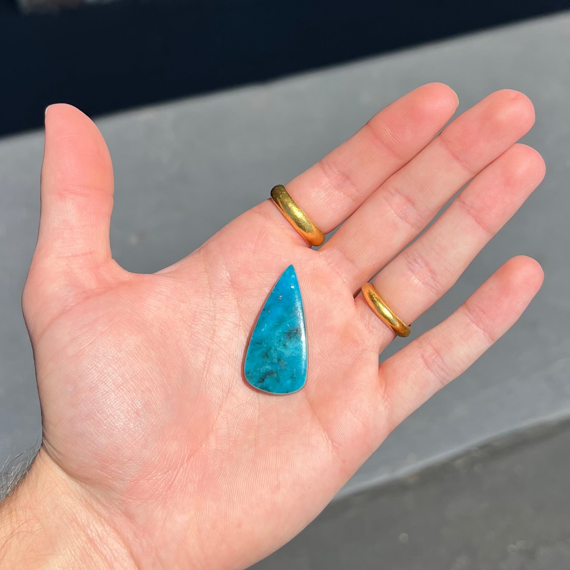 A loose, pear shaped turquoise stone from the Courtland-Gleeson mining district of Arizona.