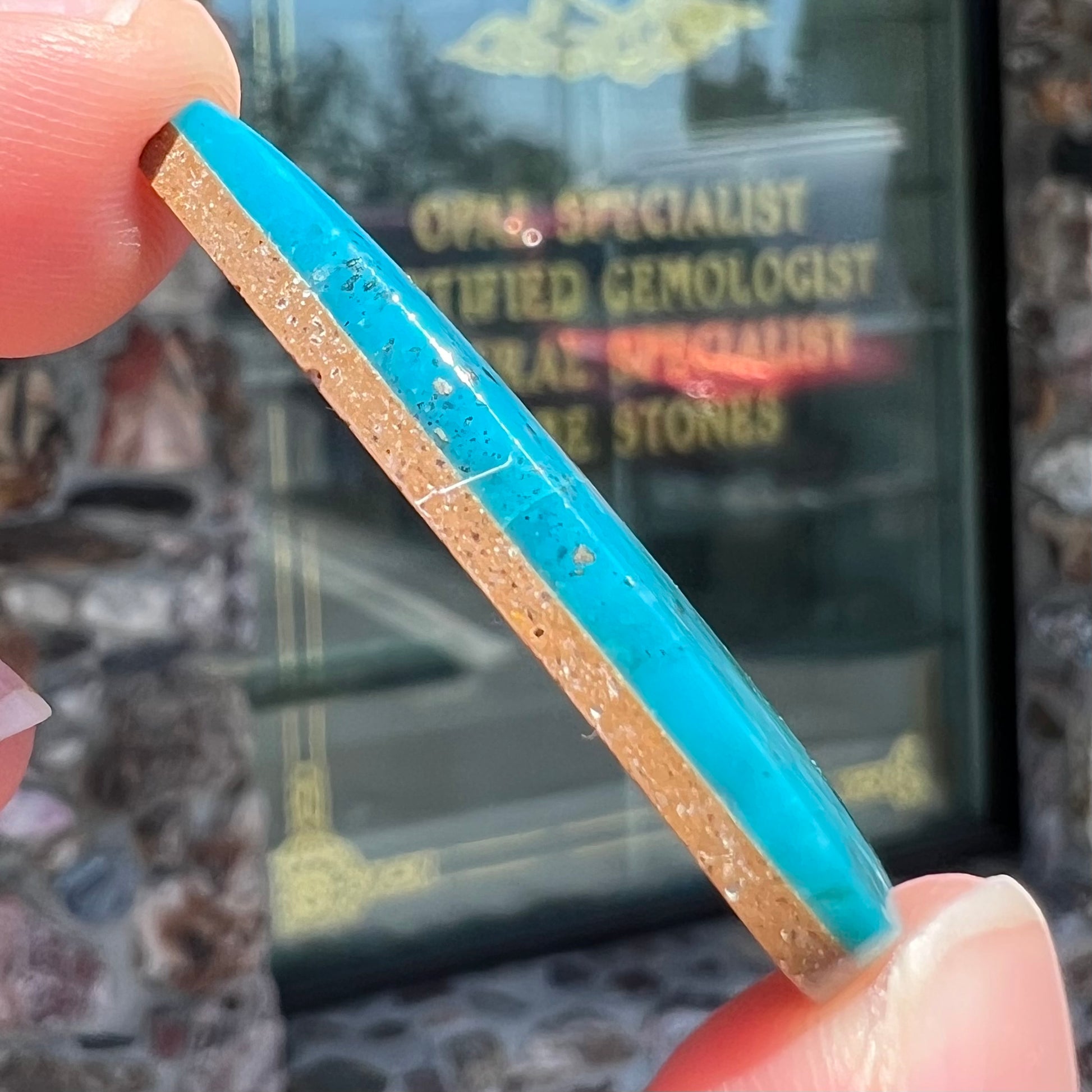 A loose, pear shaped turquoise stone from the Courtland-Gleeson mining district of Arizona.