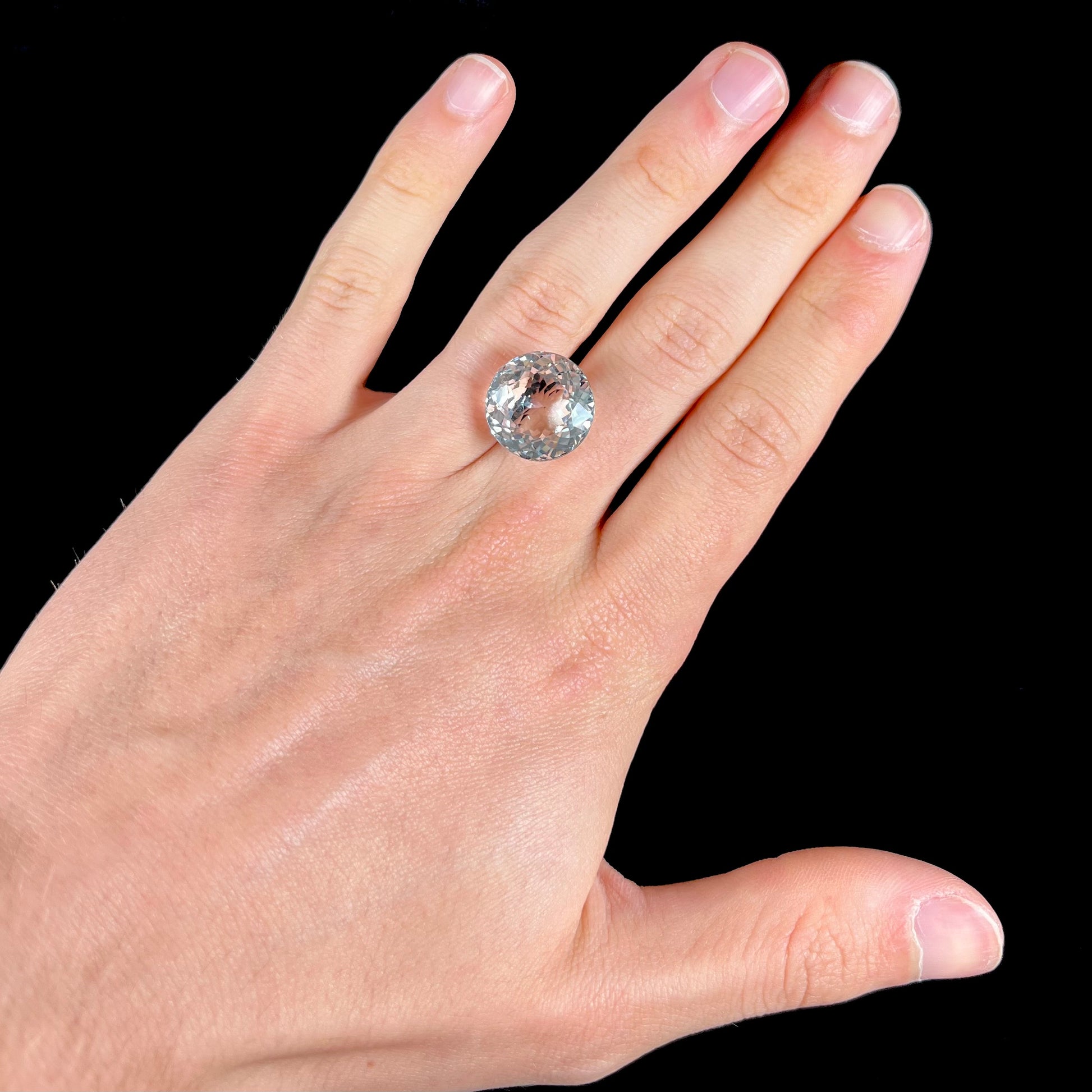 A large, round brilliant cut white topaz gemstone.