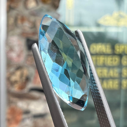 A loose, marquise cut blue topaz gemstone.