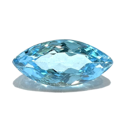 A loose, marquise cut blue topaz gemstone.