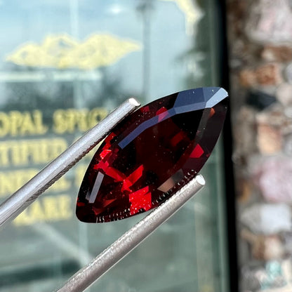 A faceted marquise cut red pyrope garnet stone.