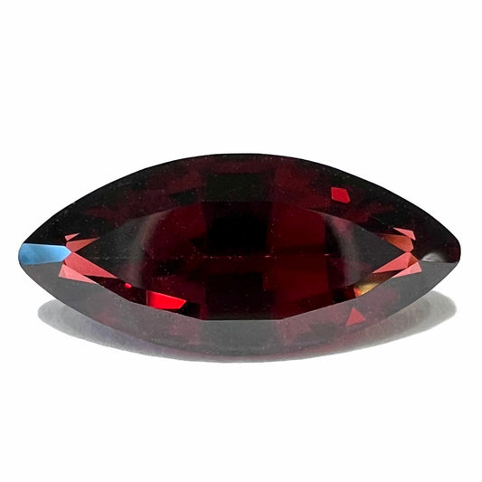 A faceted marquise cut red pyrope garnet stone.  The gem weighs 4.17 carats.