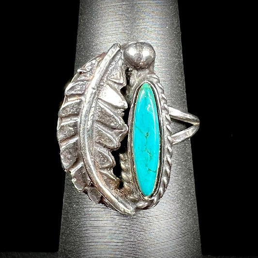 A ladies' sterling silver feather style ring set with a marquise cut turquoise stone.