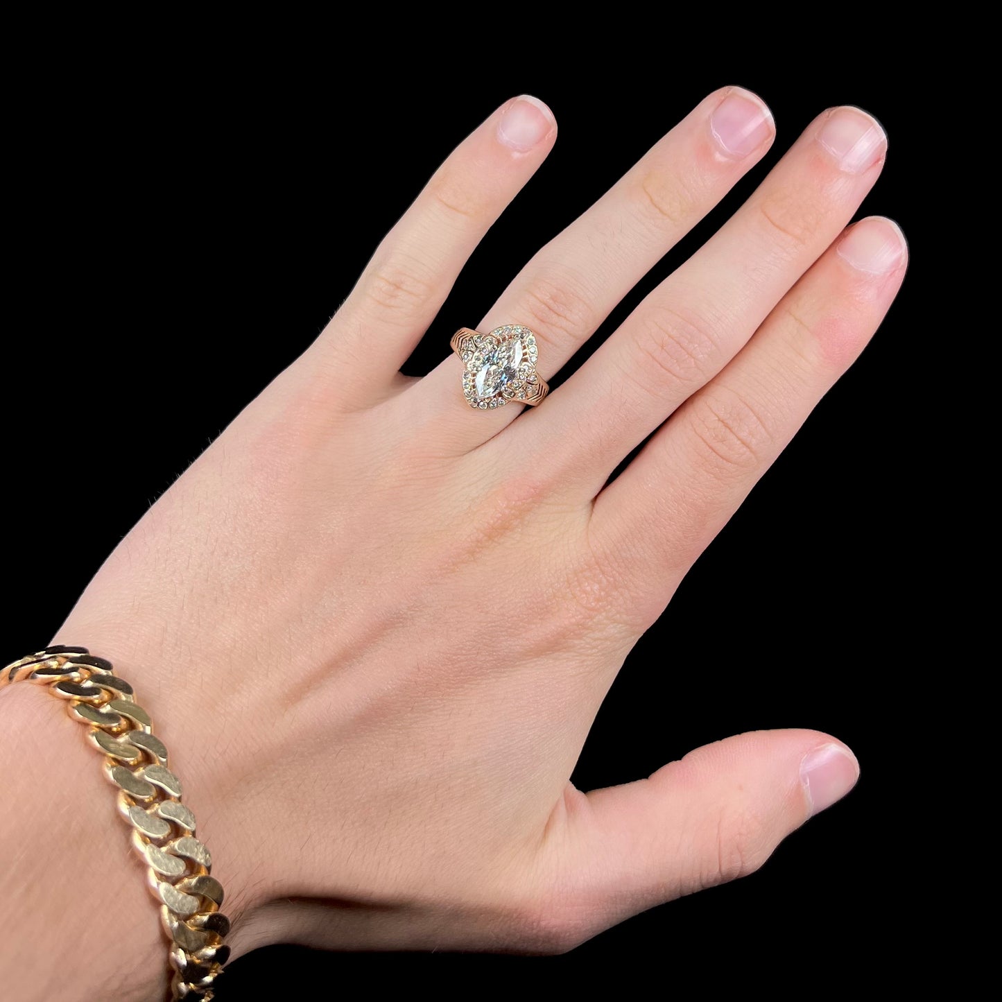A ladies' yellow gold engagement ring set with a 1.54ct marquise cut natural diamond with round diamond accents.