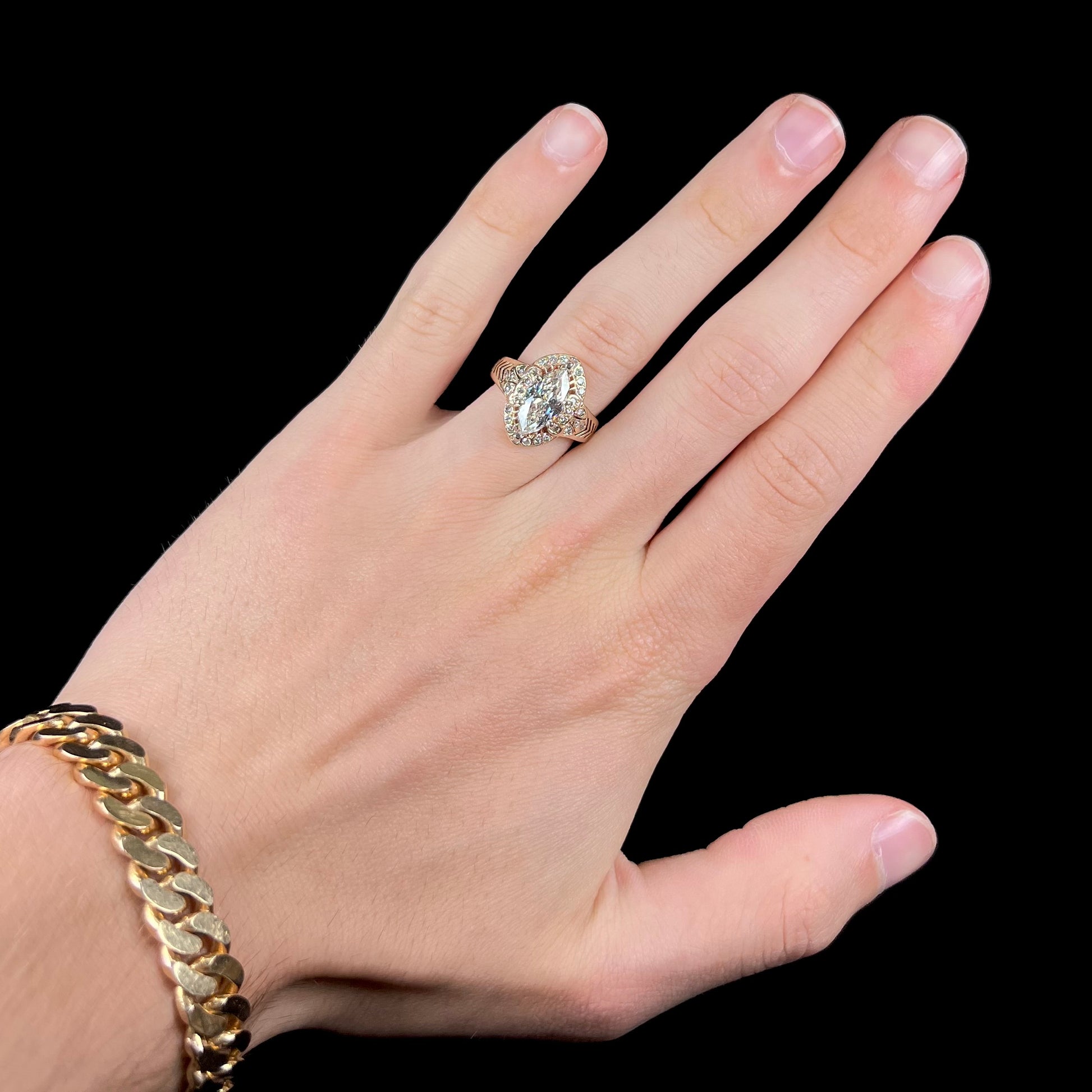 A ladies' yellow gold engagement ring set with a 1.54ct marquise cut natural diamond with round diamond accents.