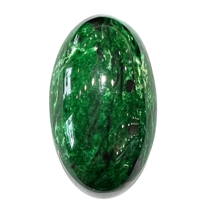 A loose, oval cabochon cut green maw sit sit stone.