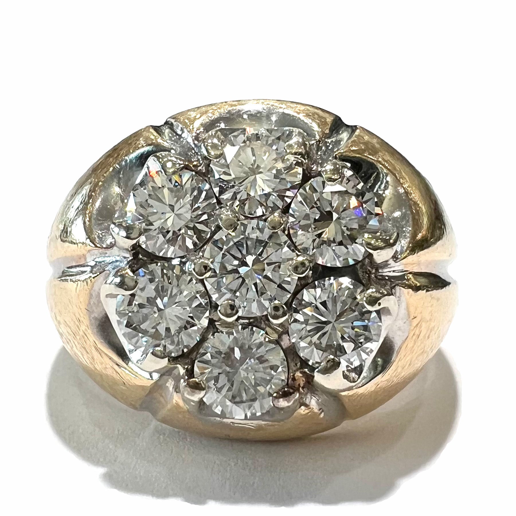 A men's textured yellow gold ring set with a cluster of seven round brilliant cut natural diamonds.