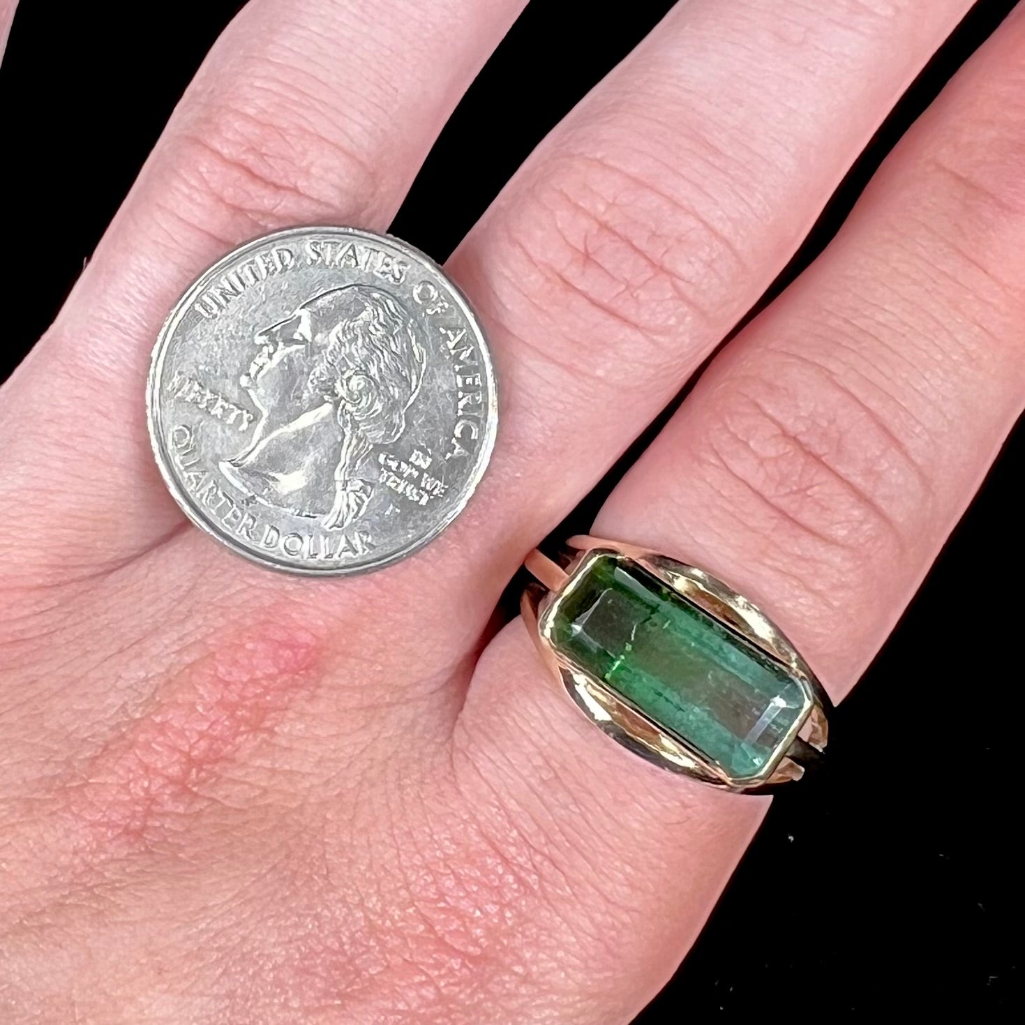 A men's emerald cut tricolor tourmaline solitaire ring in yellow gold.  The tourmaline shifts from green to blue green to blue.