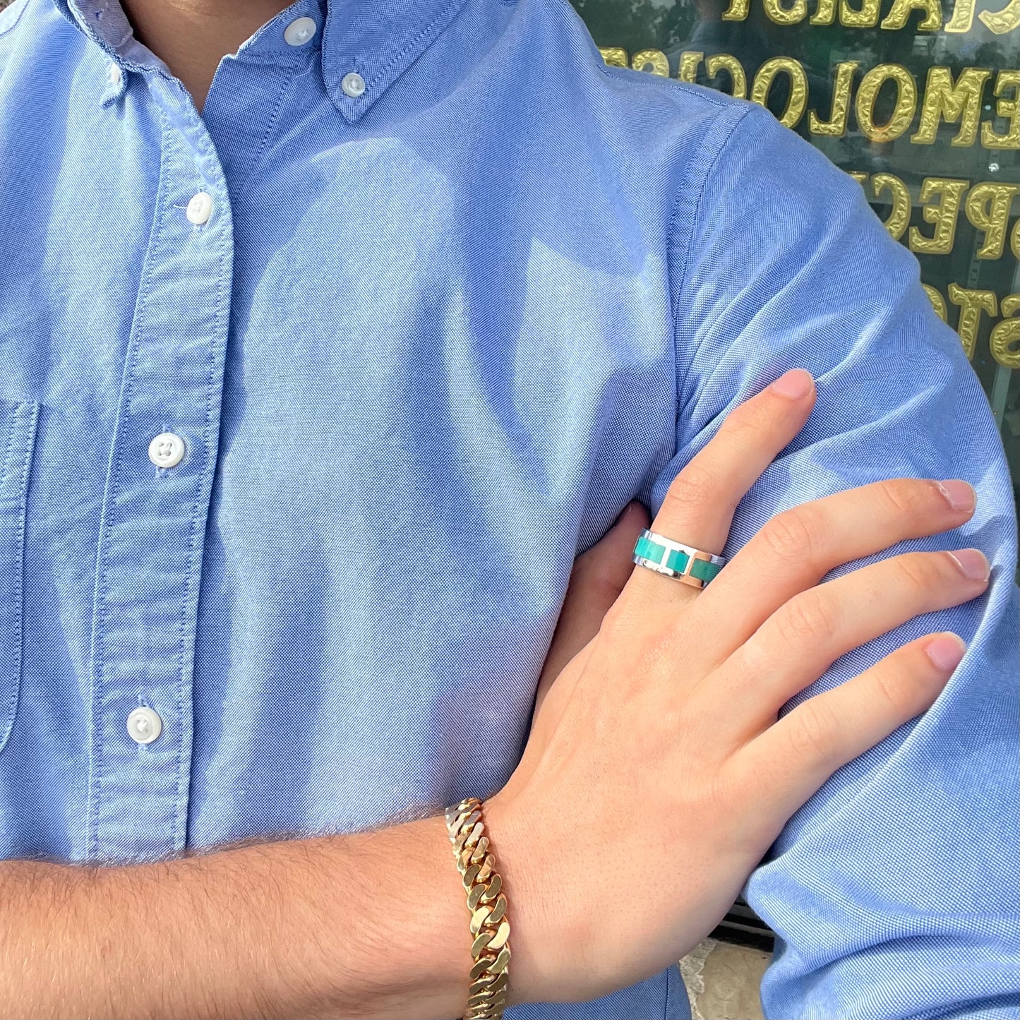 A men's sterling silver wedding band inlaid with natural Sleeping Beauty Turquoise stones that go all the way around.