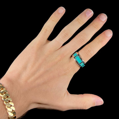 A men's sterling silver wedding band inlaid with natural Sleeping Beauty Turquoise stones that go all the way around.