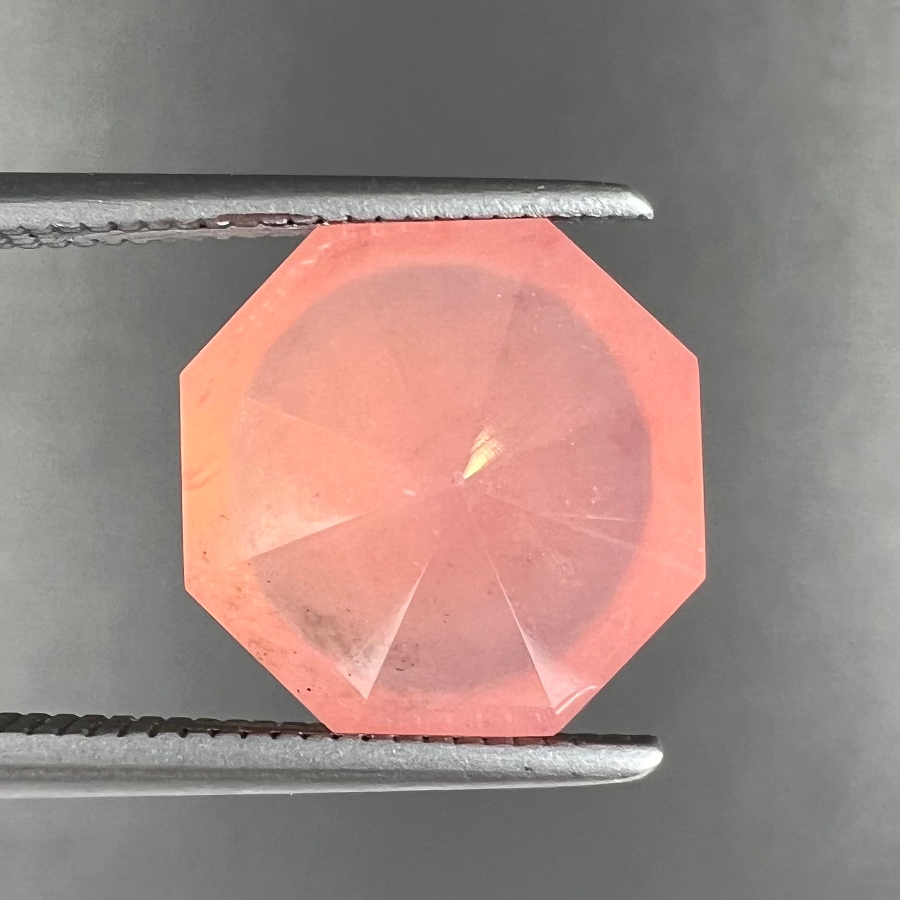 A faceted, octagon cut pink fire opal from Mexico.