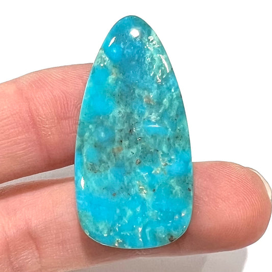 A loose, pear shaped Morenci turquoise cabochon.  The stone has pyrite inclusions.
