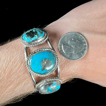 A ladies' three stone silver cuff bracelet accented with rope bezels and set with Morenci turquoise.