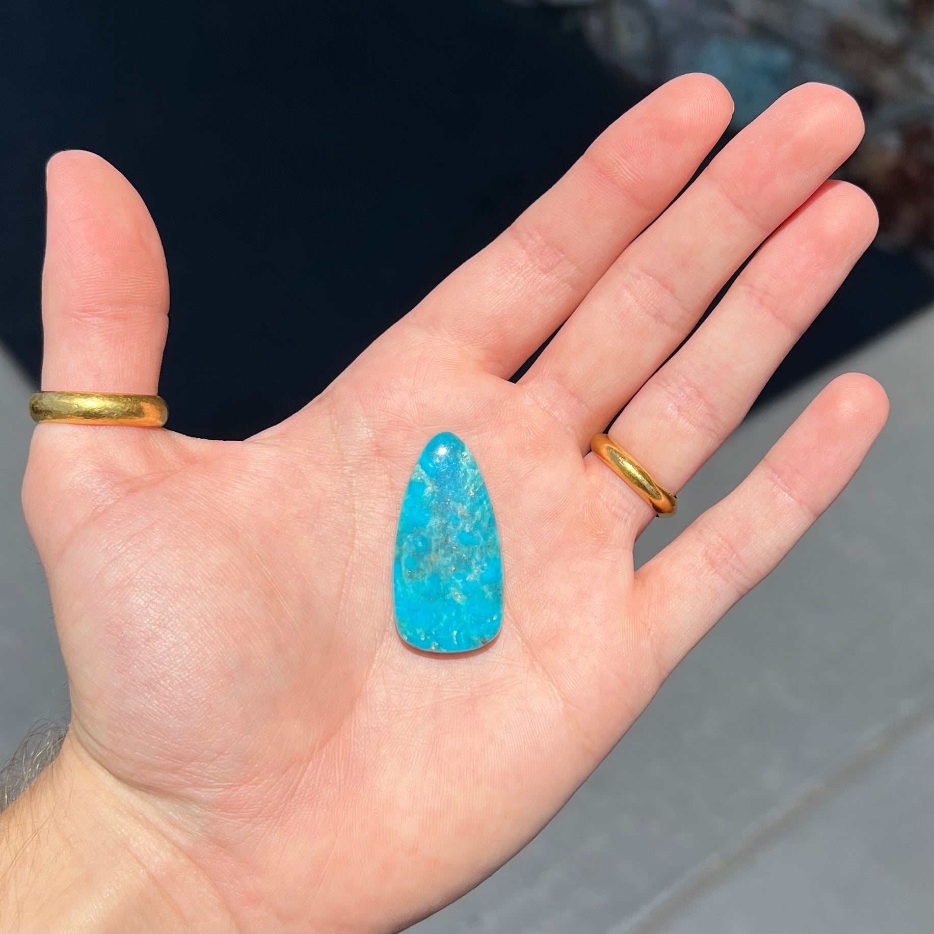 A loose, pear shaped Morenci turquoise cabochon.  The stone has pyrite inclusions.