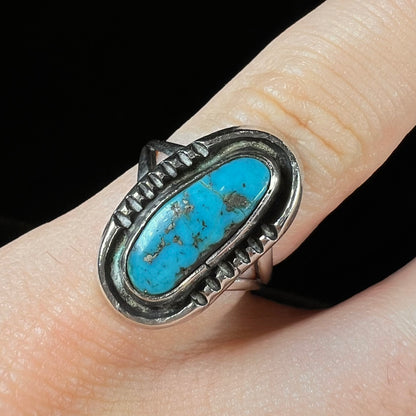 A handmade sterling silver Navajo style ring set with a Morenci turquoise stone.