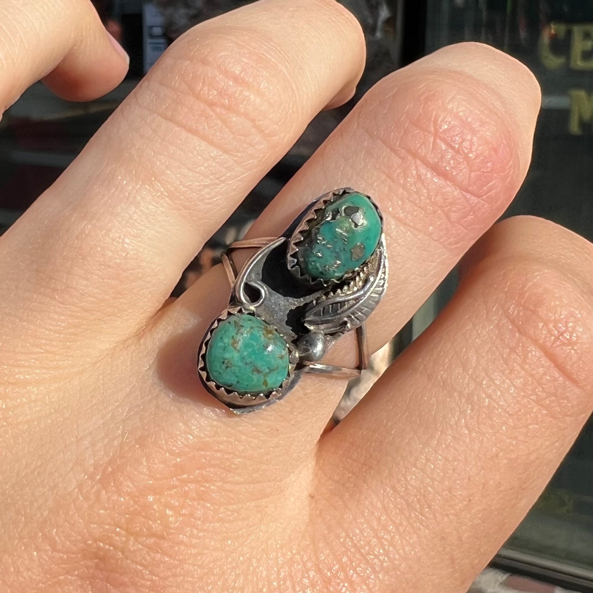 A ladies' sterling silver and green Morenci turquoise ring.  The ring is handmade in the Navajo style.