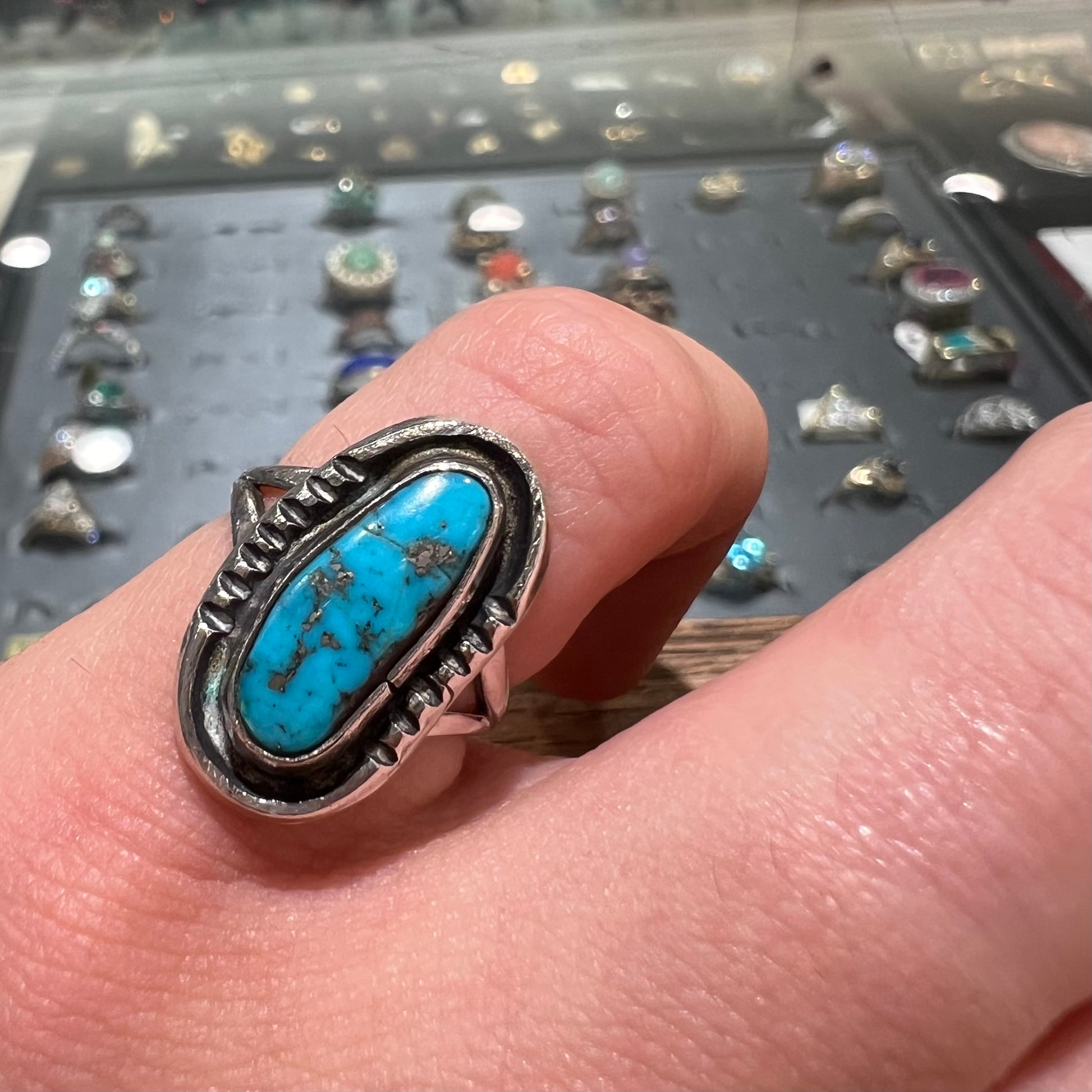 A handmade sterling silver Navajo style ring set with a Morenci turquoise stone.