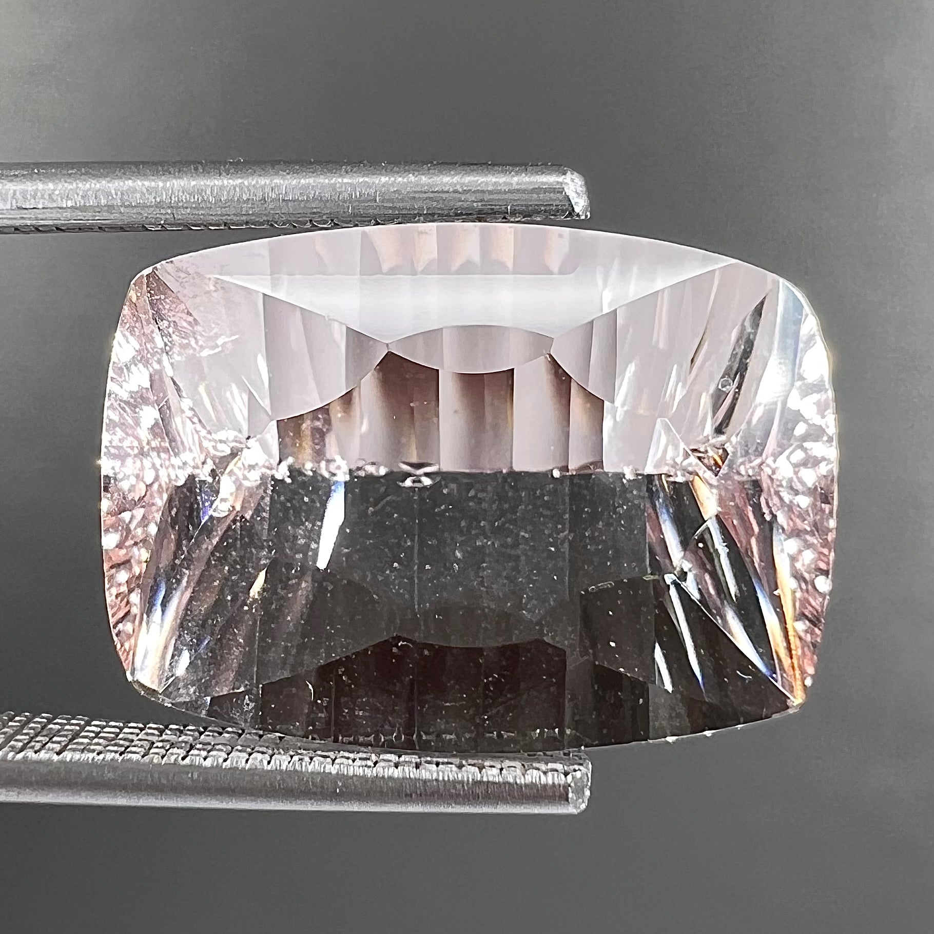 A loose, modified cushion cut pink morganite stone.