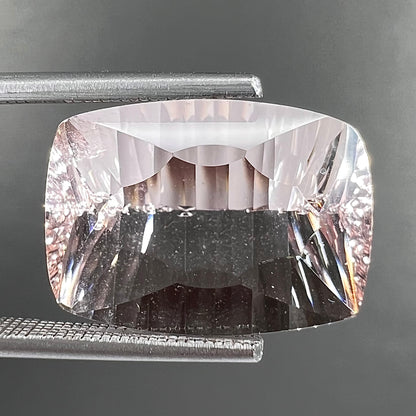 A loose, modified cushion cut pink morganite stone.