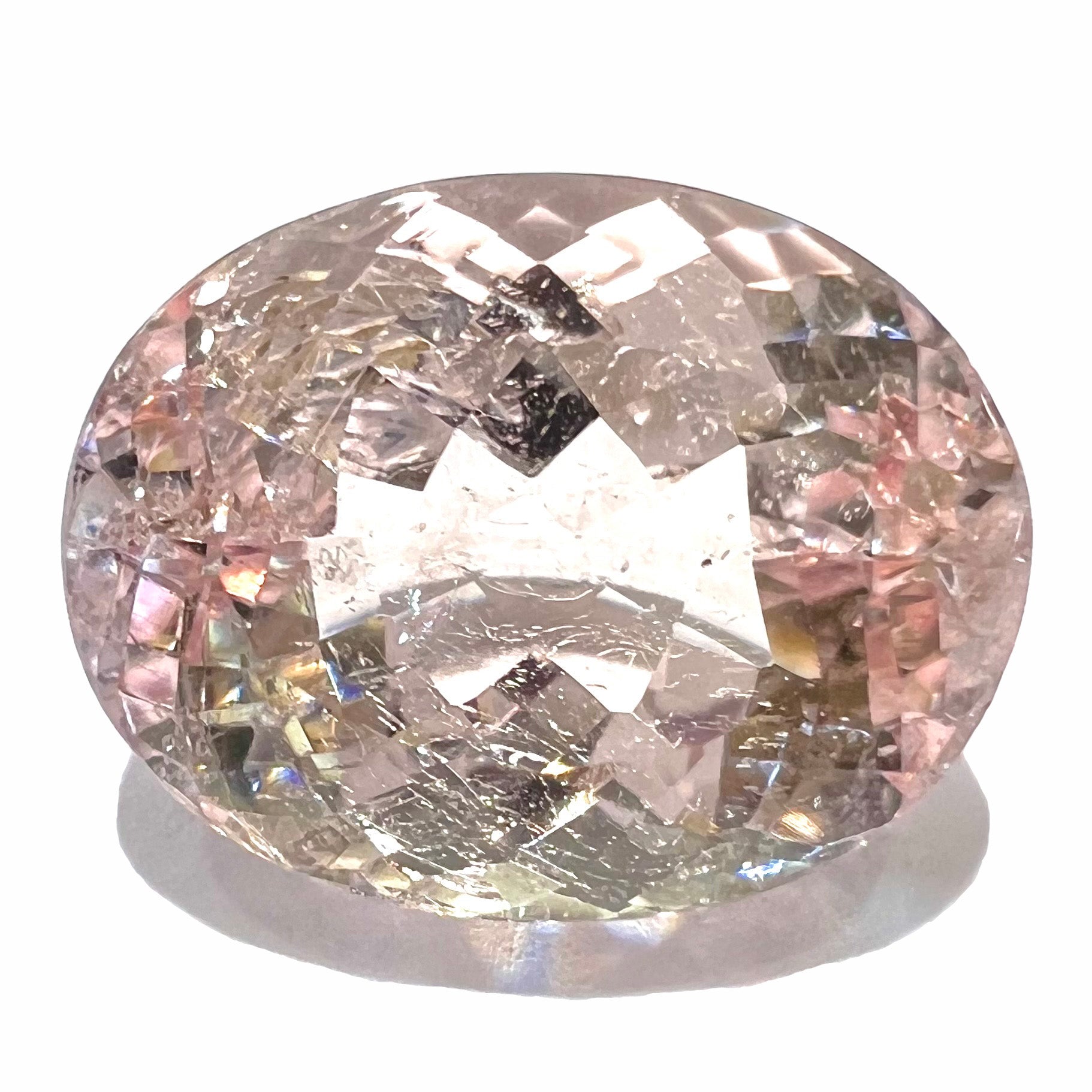 A loose, faceted oval cut pink morganite stone weighing 14.84 carats.