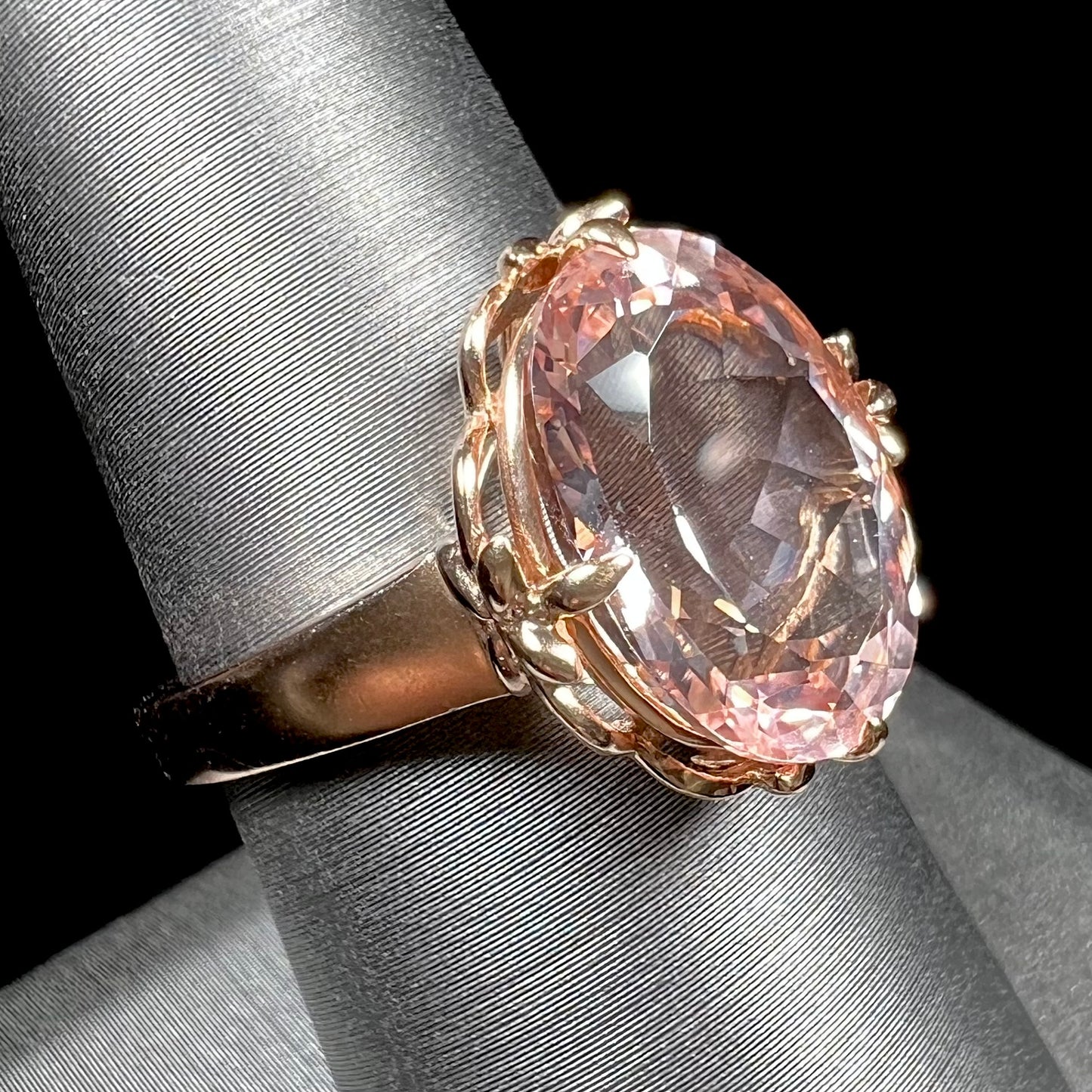 A ladies' rose gold solitaire ring set with an oval cut pink morganite gemstone.