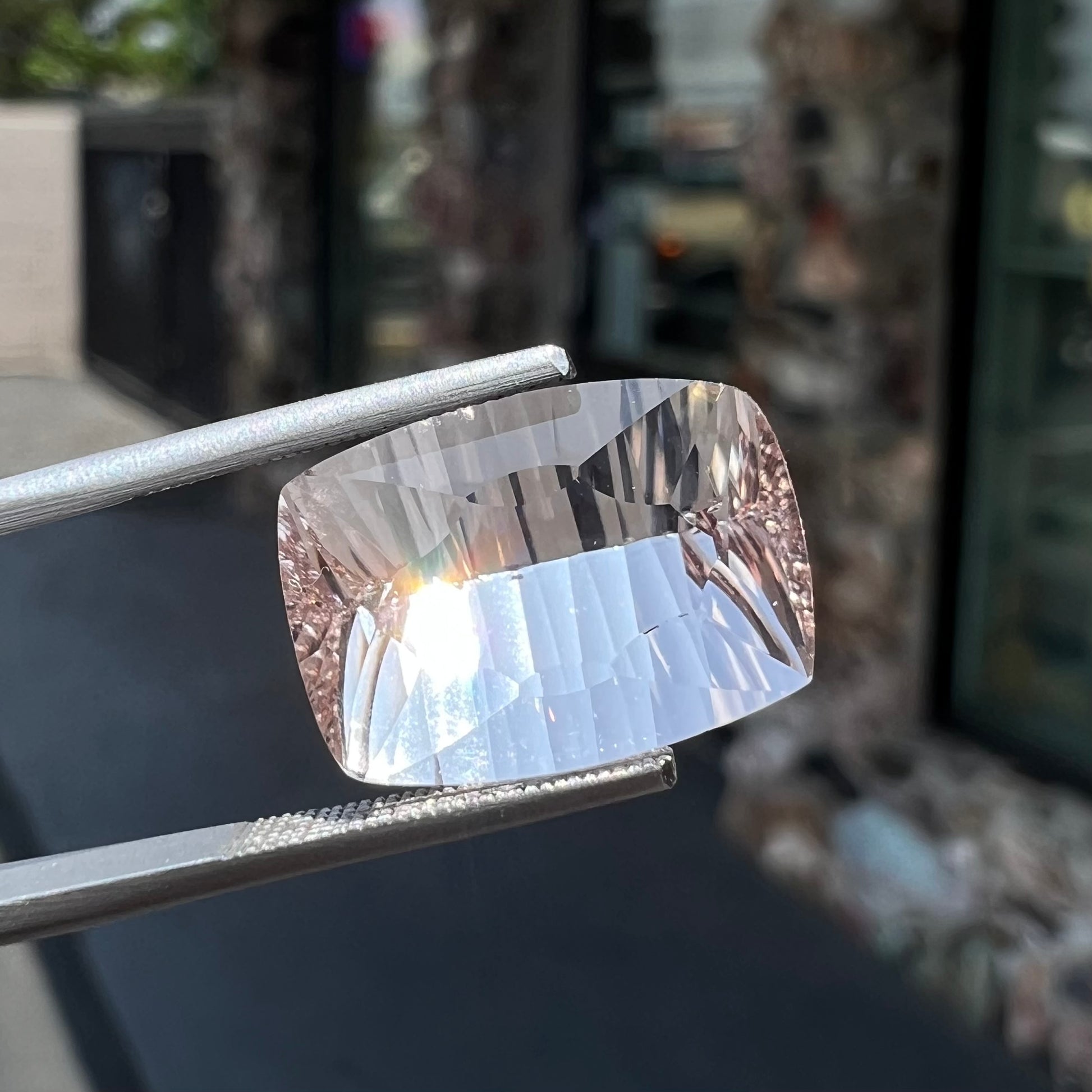A loose, modified cushion cut pink morganite stone.
