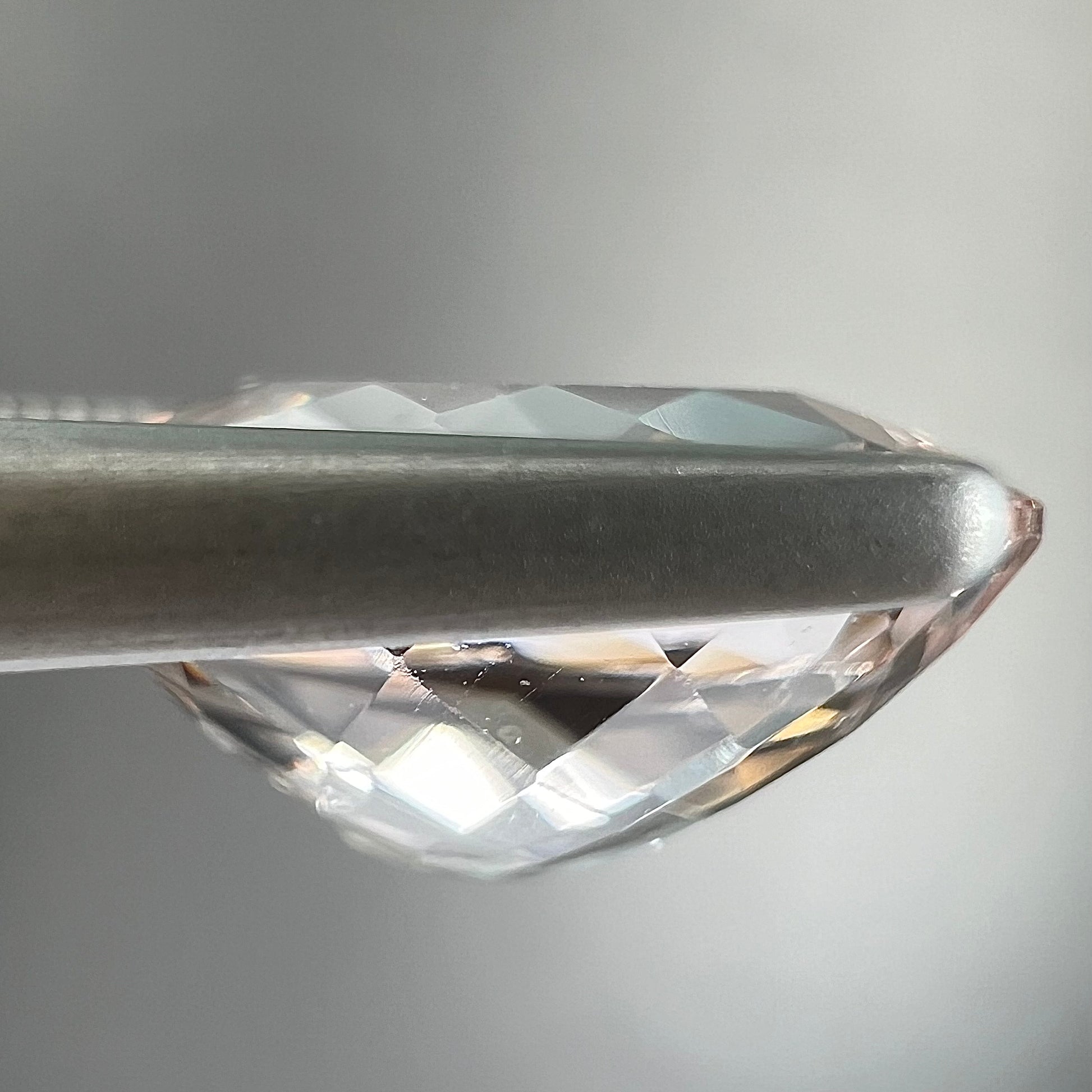 A loose, faceted oval cut pink morganite gemstone.