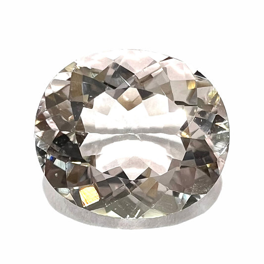 A loose, faceted oval cut pink morganite gemstone.