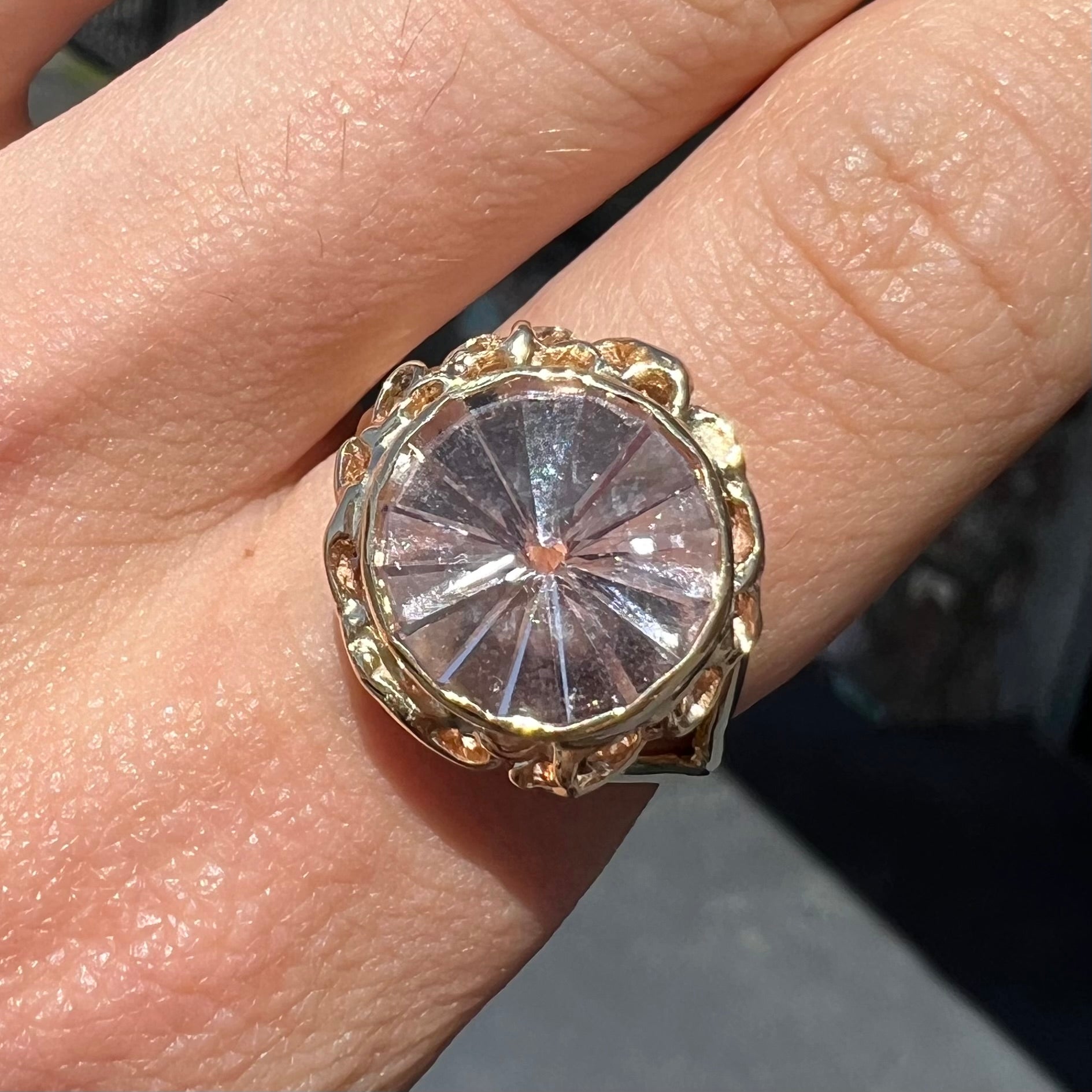 A ladies' yellow gold solitaire ring bezel set with a modified bud cut morganite gemstone.
