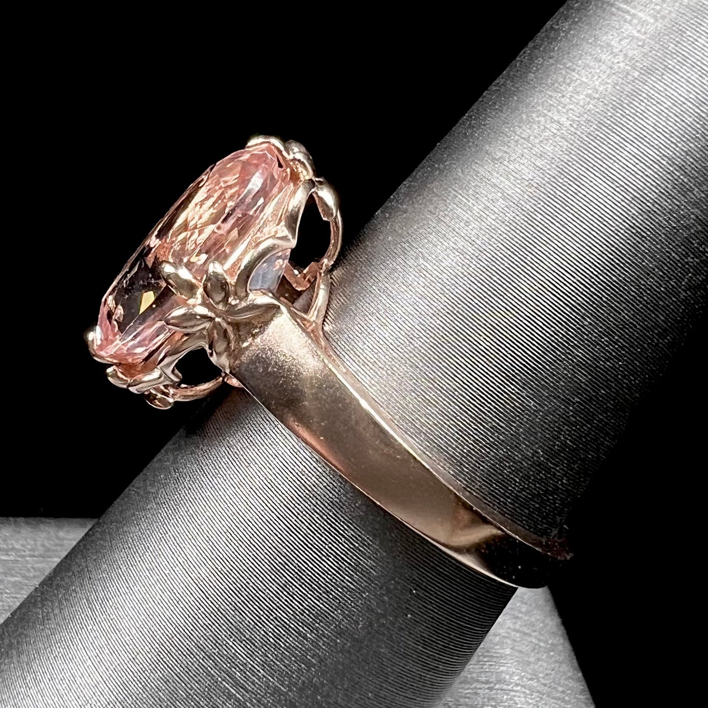 A ladies' rose gold solitaire ring set with an oval cut pink morganite gemstone.