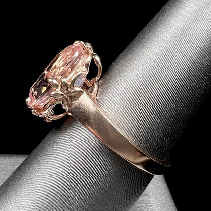 A ladies' rose gold solitaire ring set with an oval cut pink morganite gemstone.