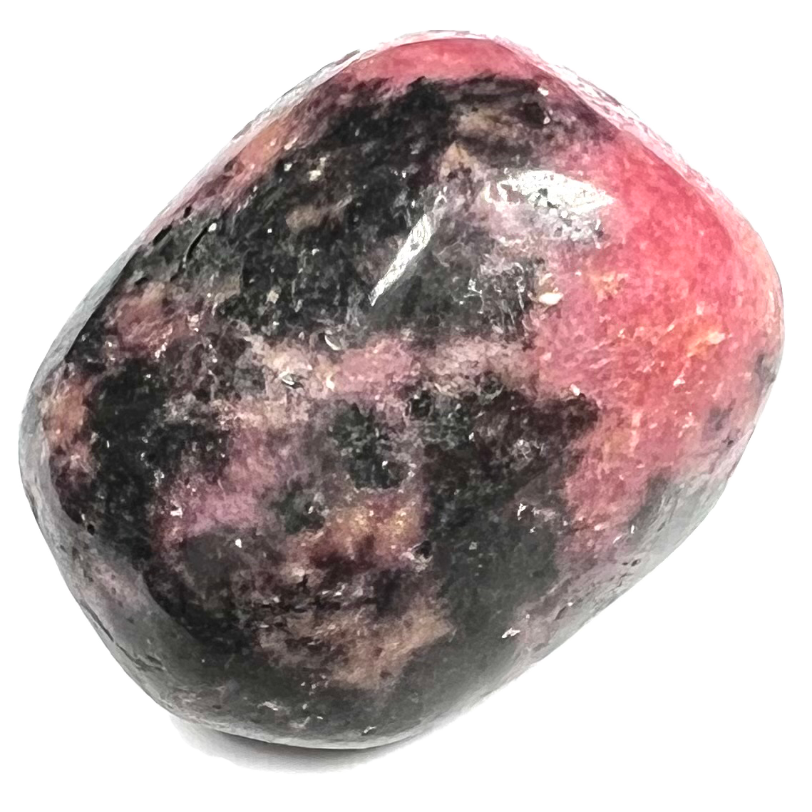 A tumbled rhodonite stone from Mozambique, East Africa.  The stone is pink with black spotting.