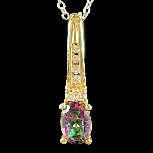 Yellow gold oval cut mystic topaz pendant with round cut diamond accents.  The sides of the pendant say "I LOVE YOU."